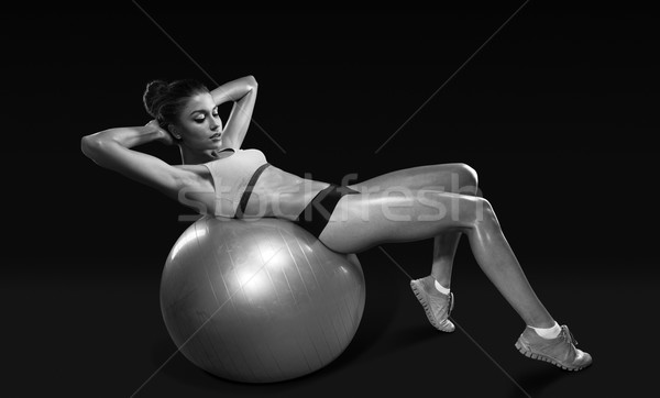 Fitness young woman doing abdominal crunch on fitness ball Stock photo © restyler