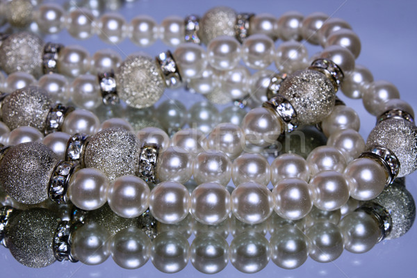 String of artificial pearls on a mirror with reflection  Stock photo © restyler