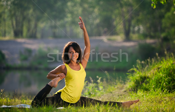 woman performs yoga exercises and Pilates in nature Stock photo © restyler