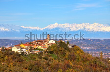Small town on the hill and snowy mountains on background. Stock photo © rglinsky77