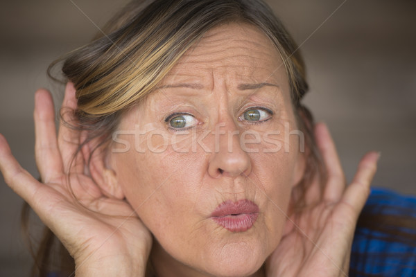 Woman listening surprised to sound and noises Stock photo © roboriginal