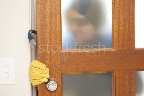 Burglar breaking in house with crowbar Stock photo © roboriginal