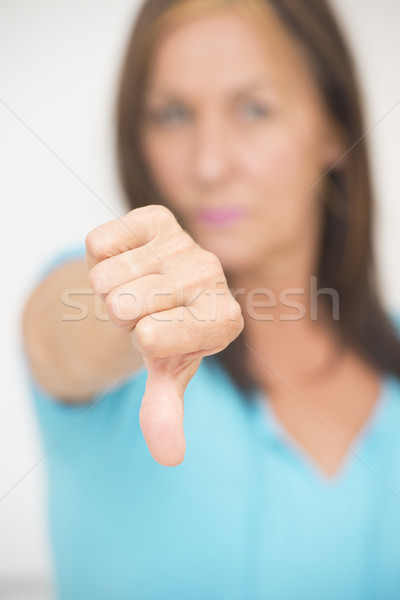Negatywne kobieta kciuk w dół portret zamazany Zdjęcia stock © roboriginal