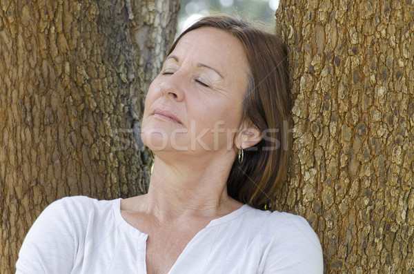 Stock photo: Mature woman relaxed closed eyes outdoor