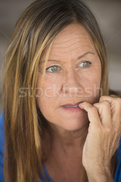 Stressed woman biting insecure finger nails Stock photo © roboriginal