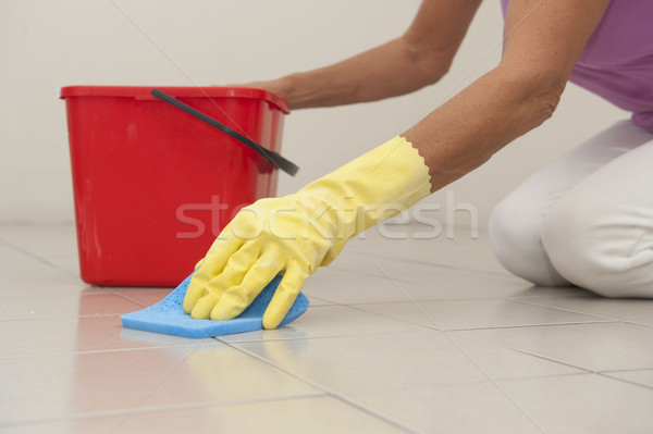 Cleaning floor tiles with sponge and glove. Stock photo © roboriginal
