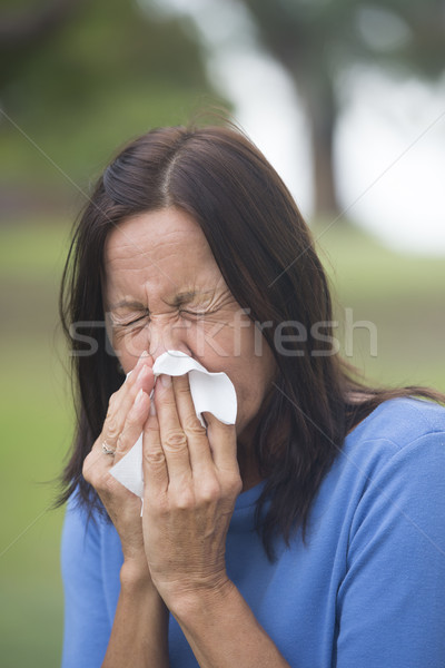 Woman sneezing tissue with flu or hayfever Stock photo © roboriginal