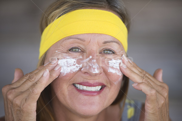Skin care moisturiser joyful mature woman Stock photo © roboriginal
