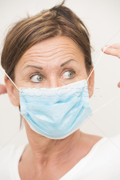 Woman nurse/doctor with mask over face Stock photo © roboriginal