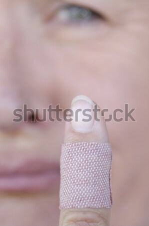 Sad woman with band aid injured finger Stock photo © roboriginal