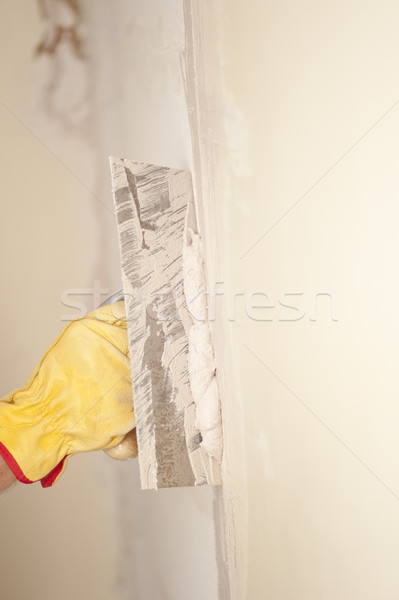 Home wall renovation with scraper and cement Stock photo © roboriginal