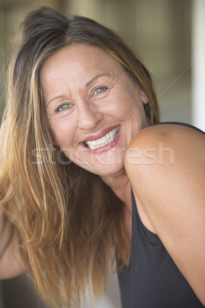 Attractive mature woman playing with long hair Stock photo © roboriginal