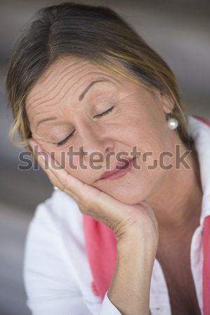Sad contemplating mature woman resting in bed Stock photo © roboriginal