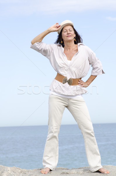 Confident mature woman ocean background Stock photo © roboriginal