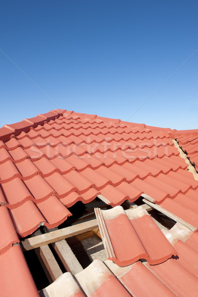 Damaged red tile roof construction house Stock photo © roboriginal