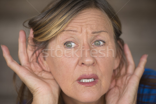 Woman listening interested to sound and noises Stock photo © roboriginal