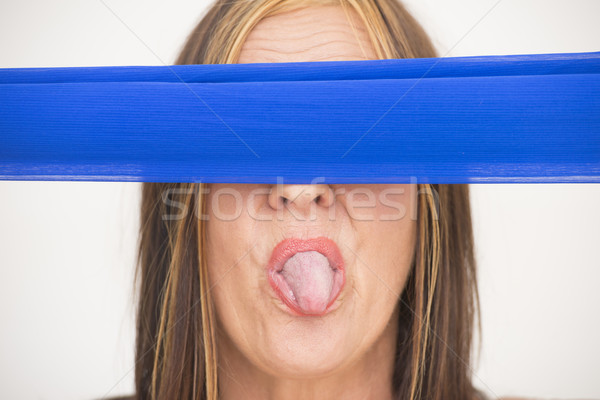 Blindfold woman sticking tongue out Stock photo © roboriginal