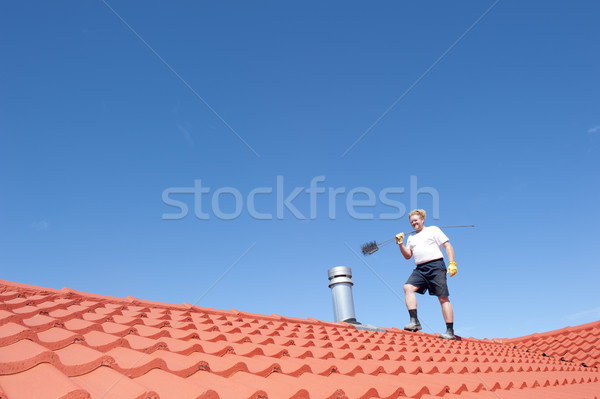 Man cleaning chimney on tiled roof Stock photo © roboriginal