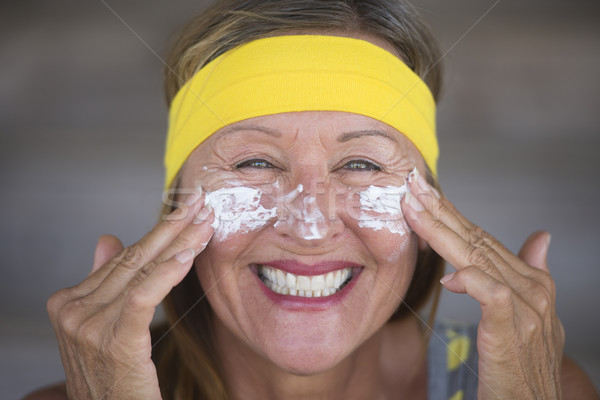 Skin care lotion joyful mature woman Stock photo © roboriginal
