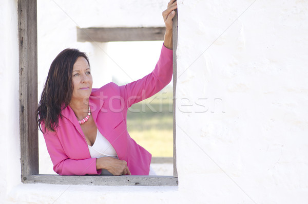 Sexy serious mature woman in pink outdoor Stock photo © roboriginal