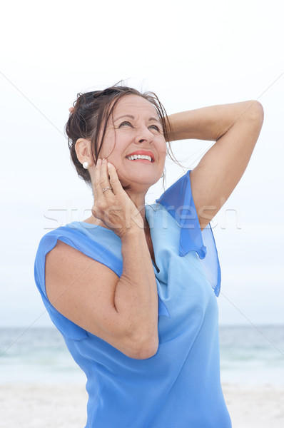 Porträt glücklich reife Frau blau Bluse anziehend Stock foto © roboriginal