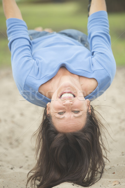 Attractive mature woman happy on swing  Stock photo © roboriginal