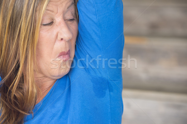 Embarassed Woman sweating under arm Stock photo © roboriginal