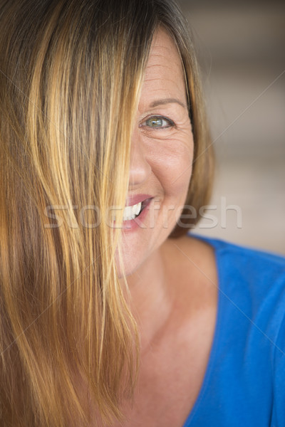 Joyful woman hair covering face portrait Stock photo © roboriginal