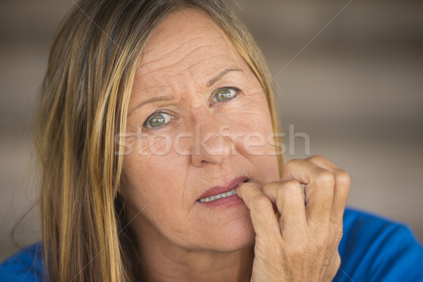 Insecure woman biting finger nails Stock photo © roboriginal