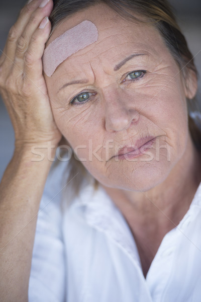 Woman with band aid suffering headache  Stock photo © roboriginal