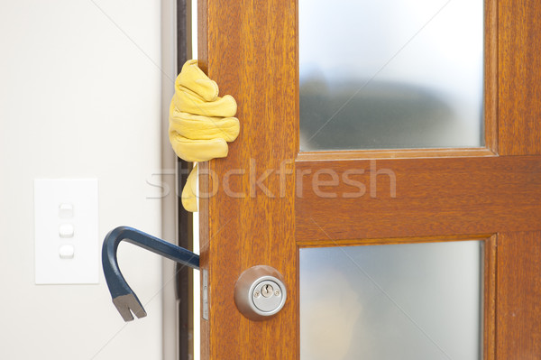 Stock photo: Robber breaking in house with crowbar