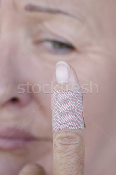 Stressed woman with band aid injured finger Stock photo © roboriginal