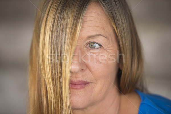 Friendly woman hair covering face portrait Stock photo © roboriginal