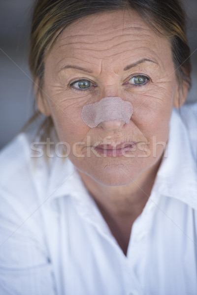 Confident woman with band aid on injured nose Stock photo © roboriginal