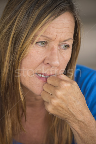 Lonely nervous woman biting insecure finger nails Stock photo © roboriginal