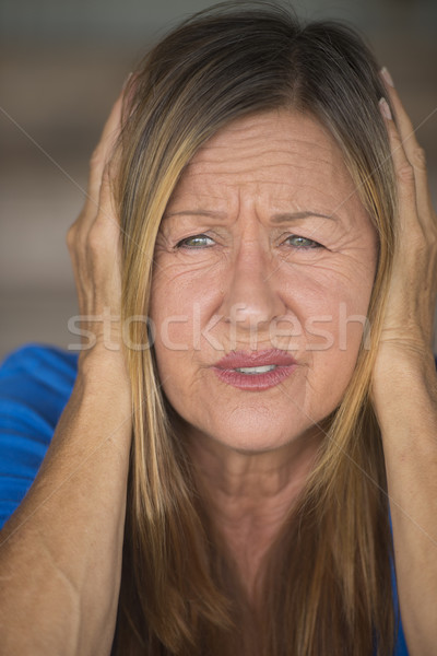 Stressed woman covering ears from sound Stock photo © roboriginal