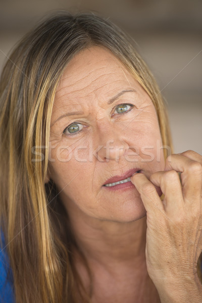 Insecure woman biting nervous finger nails Stock photo © roboriginal
