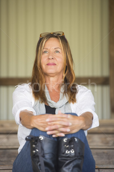 Mature woman sitting relaxed smiling outdoor Stock photo © roboriginal