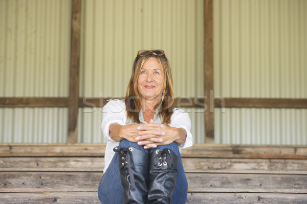 Mature woman sitting confident smiling outdoor Stock photo © roboriginal