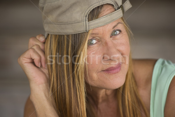 Confident attractive fit mature woman cap Stock photo © roboriginal