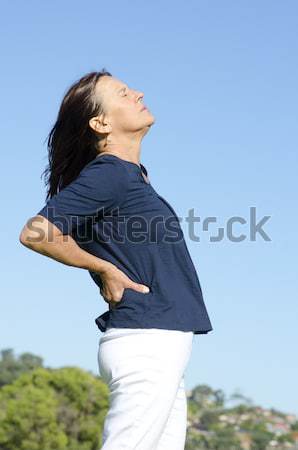 Rijpe vrouw rugpijn aantrekkelijk naar Maakt een reservekopie Stockfoto © roboriginal