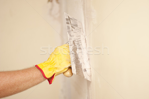 Home wall renovation with scraper and cement Stock photo © roboriginal