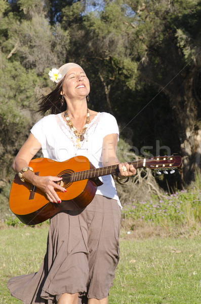 Joyful mature hippie woman with guitar Stock photo © roboriginal