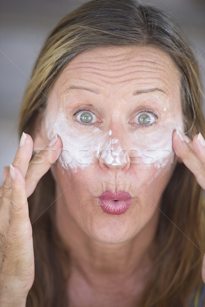 Funny mature woman face creme portrait Stock photo © roboriginal