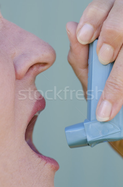 Close up woman with asthma using inhaler Stock photo © roboriginal