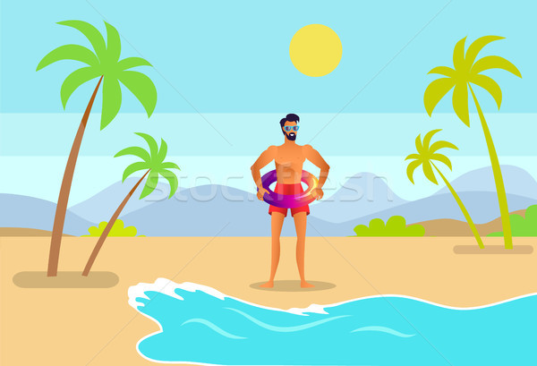 Man in Trunks with Inflatable Ring on Tropic Beach Stock photo © robuart