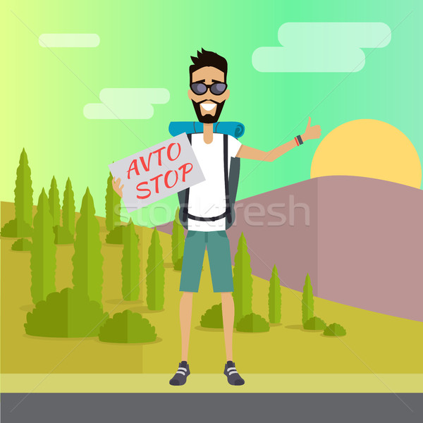 Smiling Young Man Hitchhiking Stock photo © robuart