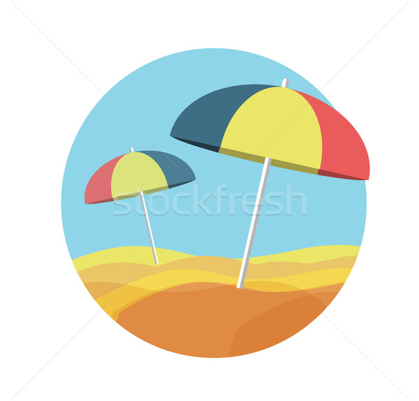 Beach umbrellas on a deserted beach Stock photo © robuart