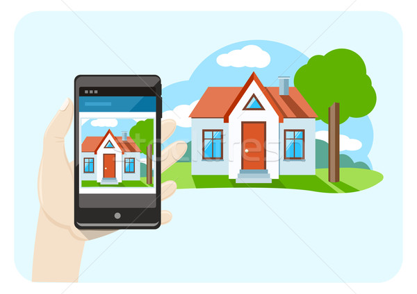 Stock photo: Hand holding mobile phone smartphone with house sale offer