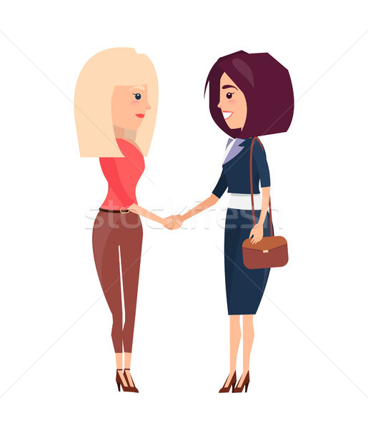 Deux femmes brunette serrer la main accueil autre Photo stock © robuart